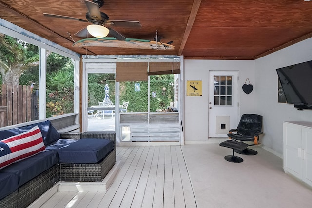 sunroom / solarium with ceiling fan and wooden ceiling