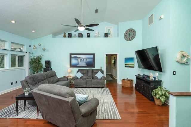 living room with ceiling fan, dark hardwood / wood-style flooring, a textured ceiling, and high vaulted ceiling