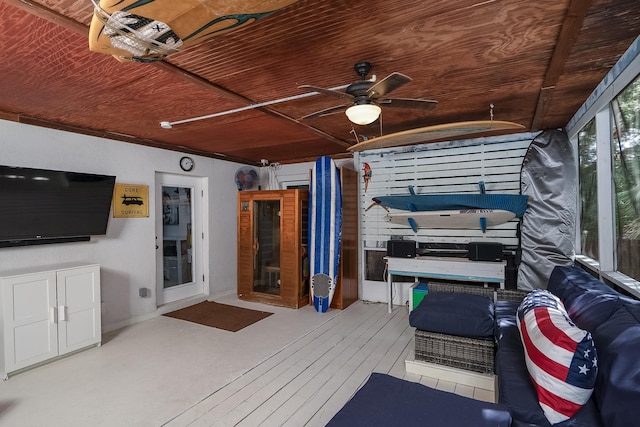 interior space featuring ceiling fan and wooden ceiling