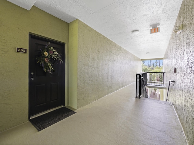 entrance to property featuring stucco siding