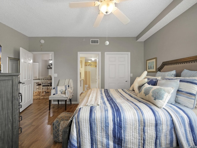bedroom featuring a textured ceiling, visible vents, a ceiling fan, wood finished floors, and ensuite bath
