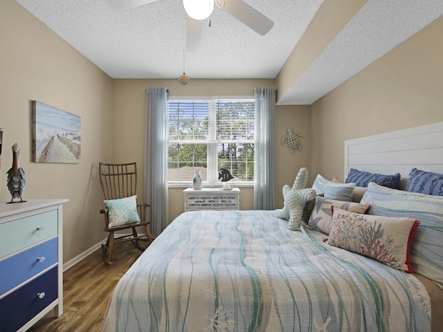 bedroom with baseboards, a textured ceiling, dark wood-style floors, and ceiling fan
