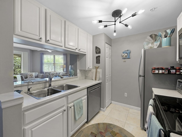 kitchen featuring range with electric cooktop, light countertops, dishwasher, a sink, and white cabinetry