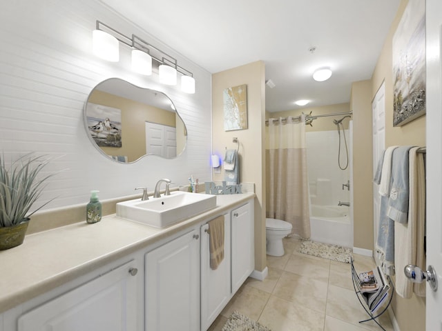 bathroom with tile patterned floors, vanity, shower / tub combo with curtain, baseboards, and toilet