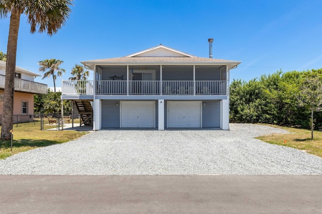 coastal home with a garage and ceiling fan