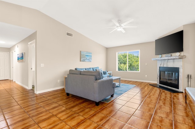 living room with a tile fireplace, tile patterned flooring, ceiling fan, and lofted ceiling