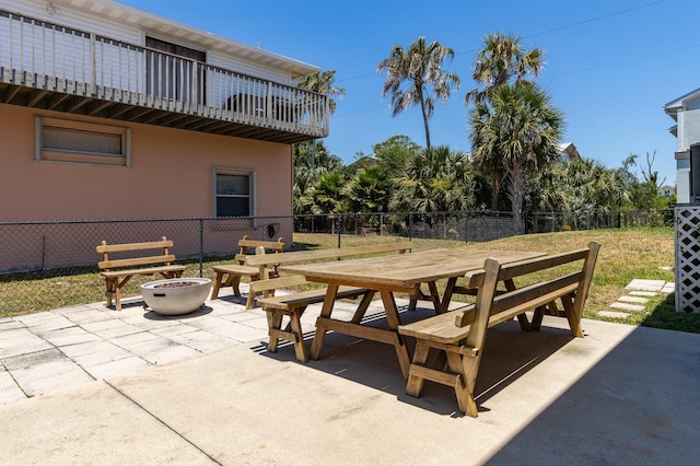 view of patio / terrace with a balcony and an outdoor fire pit