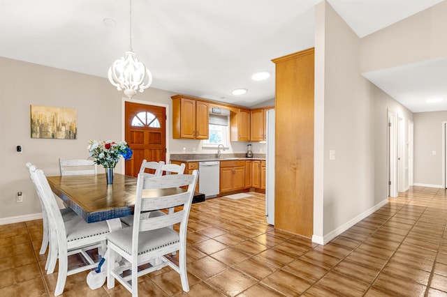 tiled dining room with a notable chandelier and sink