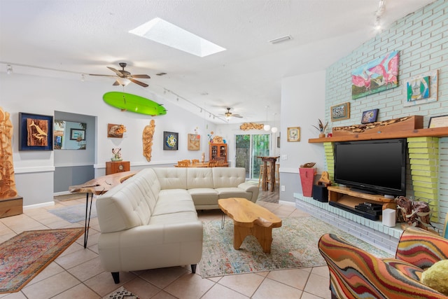 living room with a ceiling fan, tile patterned flooring, a textured ceiling, and track lighting