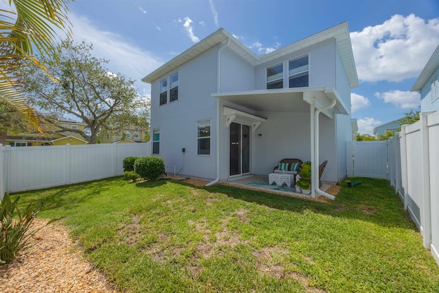 116 Serenity Bay Blvd, Saint Augustine, FL 32080 - back of house with stucco siding, a fenced backyard, and a patio area