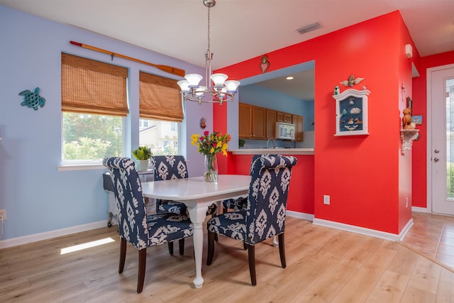 116 Serenity Bay Blvd, Saint Augustine, FL 32080 - dining space featuring a chandelier and light wood-type flooring