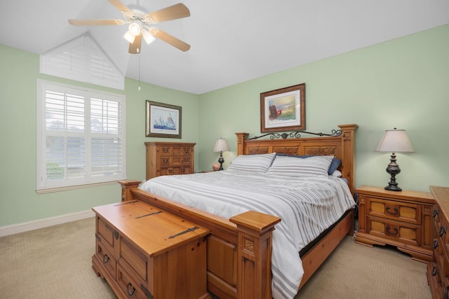 bedroom featuring light carpet, ceiling fan, baseboards, and lofted ceiling