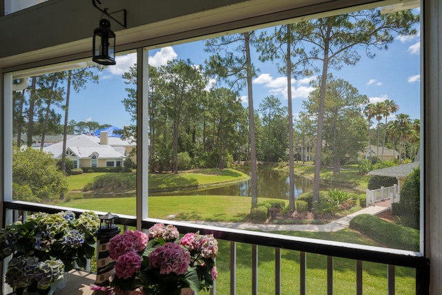 sunroom with a wealth of natural light and a water view