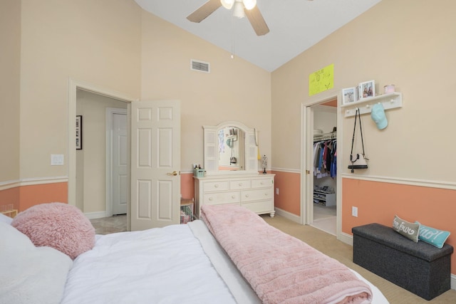 bedroom with baseboards, visible vents, light colored carpet, a spacious closet, and a closet