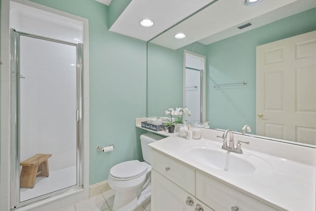 bathroom with visible vents, toilet, a shower stall, vanity, and tile patterned flooring