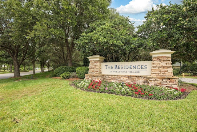 community / neighborhood sign with a lawn