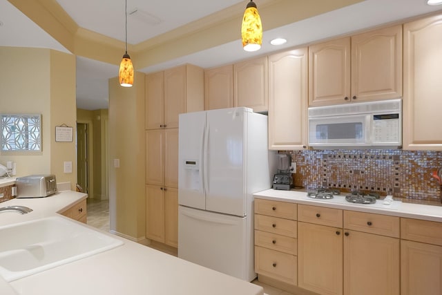 kitchen with sink, pendant lighting, white appliances, and light brown cabinets