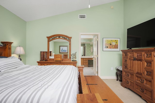 bedroom featuring lofted ceiling, light colored carpet, visible vents, ensuite bathroom, and baseboards