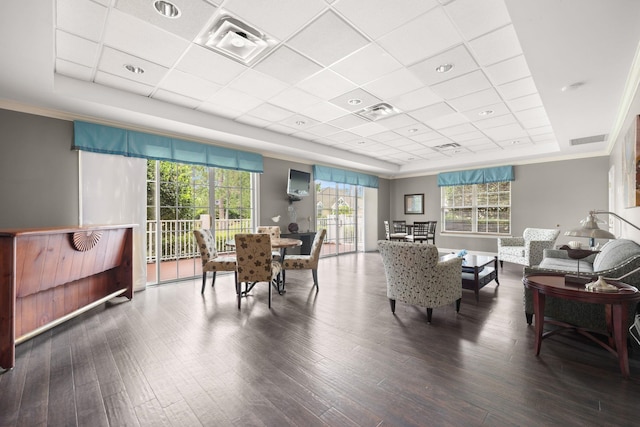 interior space with dark wood-type flooring, a raised ceiling, and visible vents