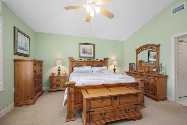 bedroom with lofted ceiling, baseboards, visible vents, and light colored carpet