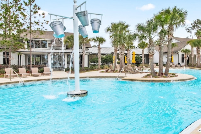 view of swimming pool featuring pool water feature and a patio