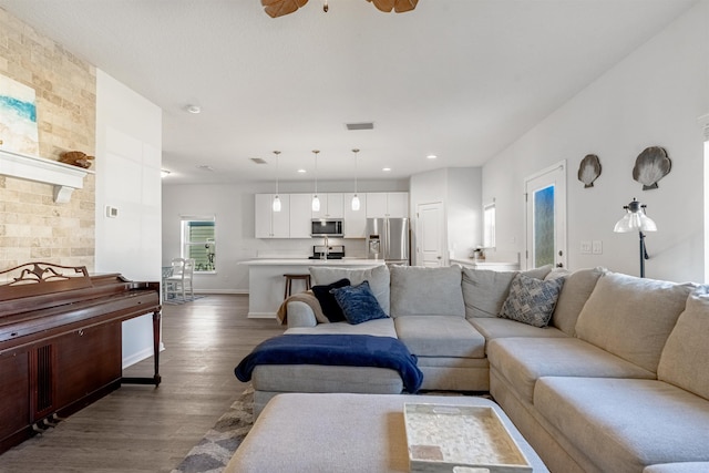 living room with hardwood / wood-style flooring and ceiling fan