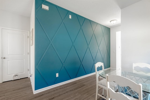 interior space with a textured ceiling and hardwood / wood-style flooring