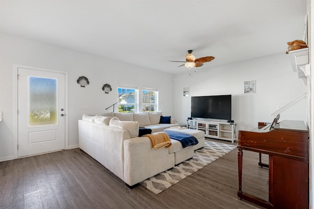 living room featuring ceiling fan and dark wood-type flooring