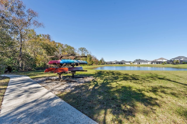 view of property's community featuring a water view and a yard