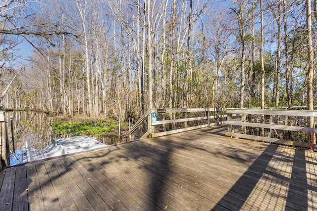 wooden terrace featuring a forest view