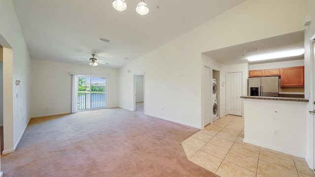 2384 Golden Lake Loop, Saint Augustine, FL 32084 - unfurnished living room with stacked washer / dryer, a ceiling fan, baseboards, and light colored carpet