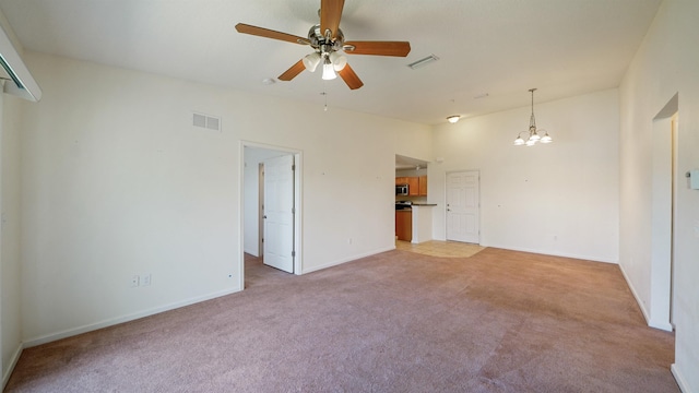 2384 Golden Lake Loop, Saint Augustine, FL 32084 - unfurnished living room featuring light carpet, a chandelier, ceiling fan, baseboards, and lofted ceiling