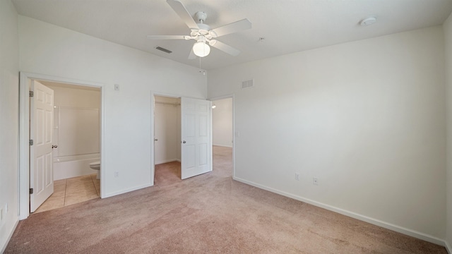 2384 Golden Lake Loop, Saint Augustine, FL 32084 - unfurnished bedroom featuring carpet floors, a spacious closet, baseboards, a closet, and connected bathroom
