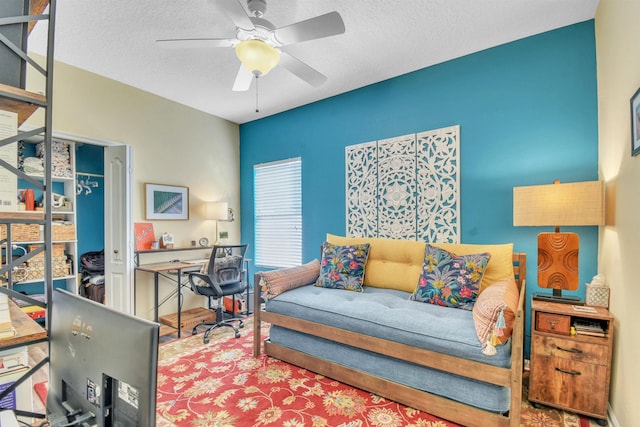 interior space with ceiling fan and a textured ceiling