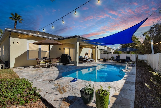 view of pool with a fenced in pool, a patio area, a fenced backyard, and a grill