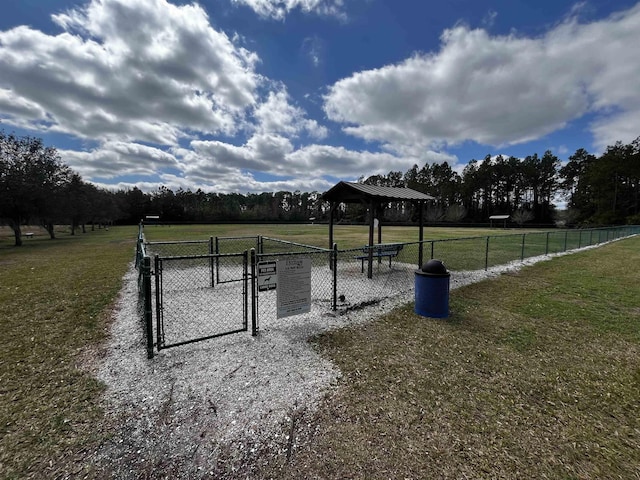 view of community featuring fence, a gazebo, and a lawn