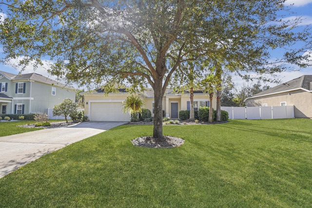 view of front of property with a garage, fence, concrete driveway, stucco siding, and a front lawn