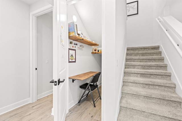 staircase with hardwood / wood-style floors