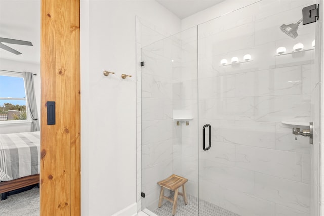 bathroom featuring ceiling fan and a shower with shower door