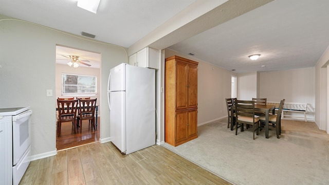 kitchen featuring ceiling fan, white cabinetry, white appliances, and light hardwood / wood-style flooring