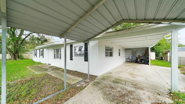 view of side of property with a lawn and a carport