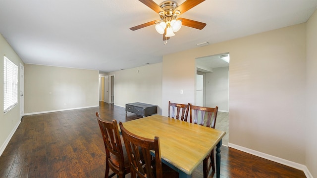 dining space featuring ceiling fan and dark wood-type flooring