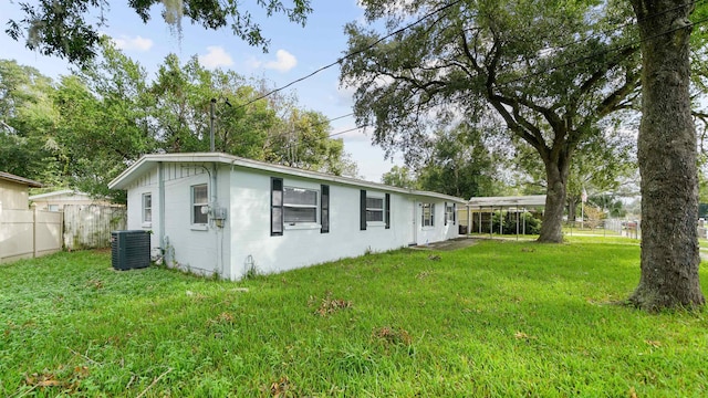 exterior space with a lawn and central AC