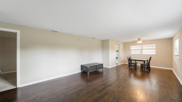 dining room with ceiling fan and dark hardwood / wood-style flooring