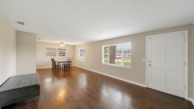 unfurnished dining area featuring ceiling fan and dark hardwood / wood-style floors