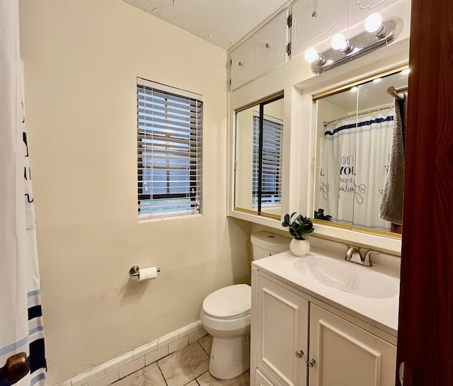 bathroom with toilet, vanity, and tile patterned floors