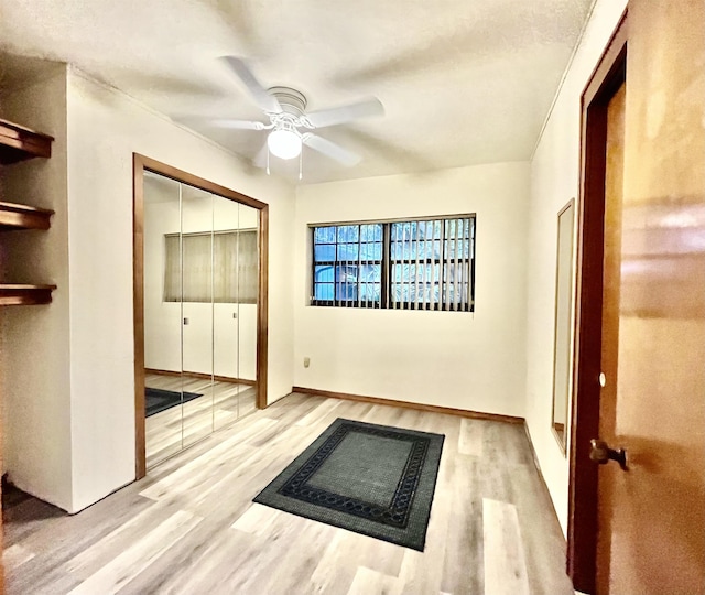 interior space featuring ceiling fan, a closet, and light hardwood / wood-style flooring