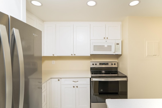 kitchen featuring white cabinets, stainless steel appliances, and light countertops