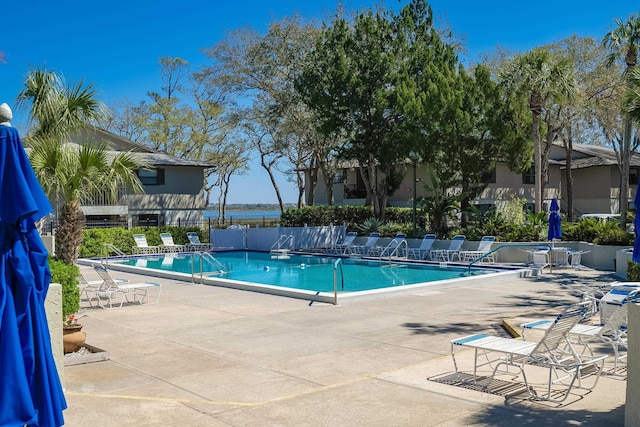 community pool featuring a patio and fence