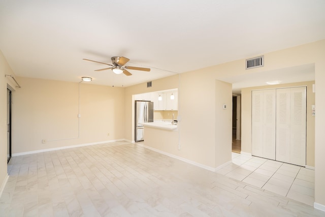 empty room featuring visible vents, baseboards, light wood-style floors, and a ceiling fan